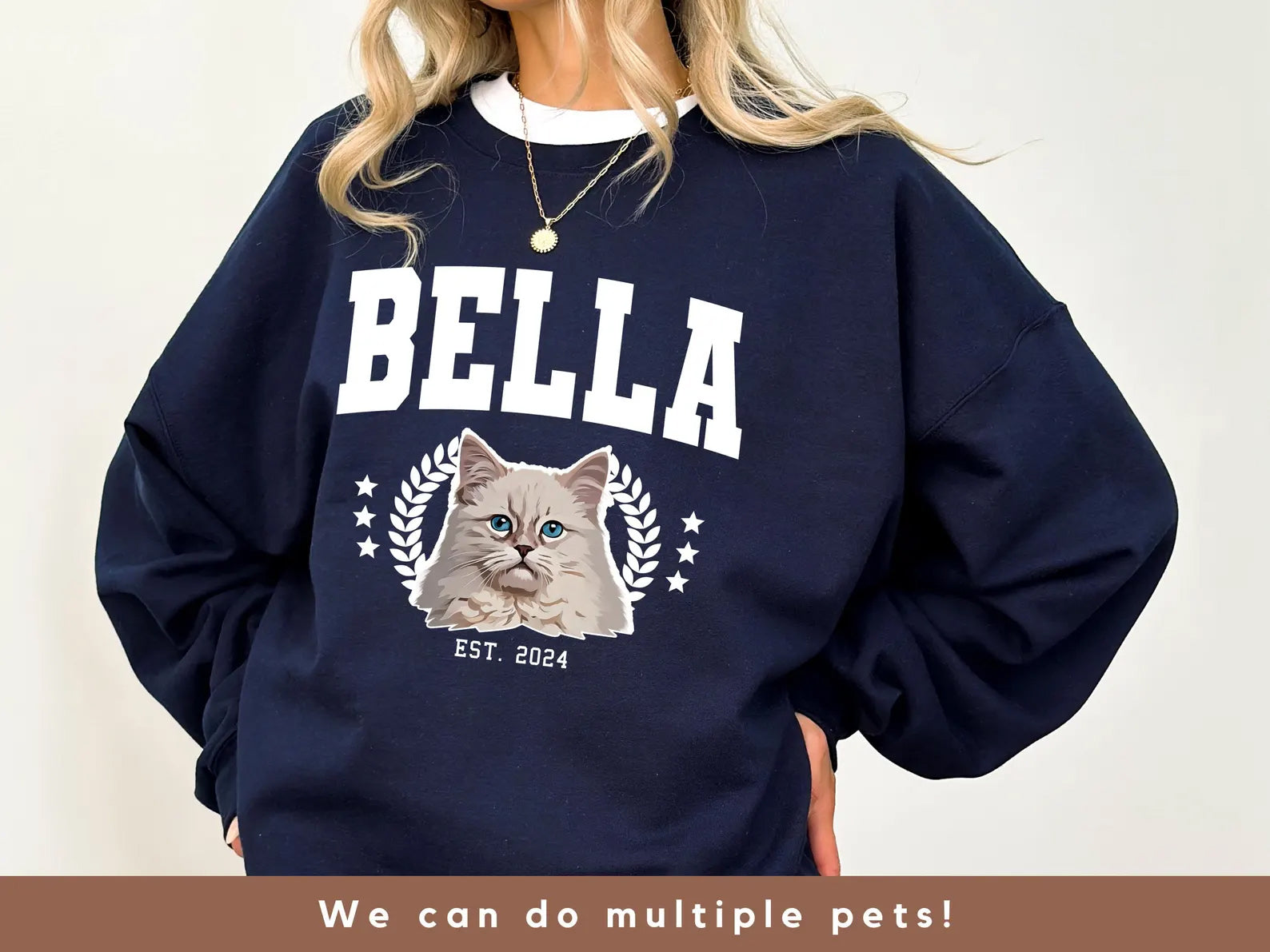 Navy blue sweatshirt with a cat graphic and 'Bella' text on a plain background